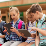 group-of-happy-elementary-school-students-talking-PT545EB